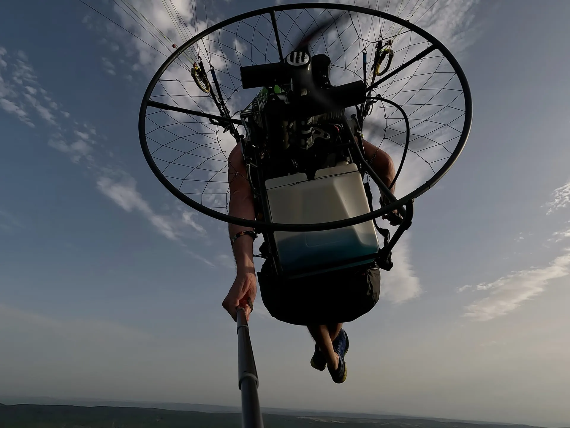 Vue depuis le dessous de la cage et du moteur en vol, ciel nuageux